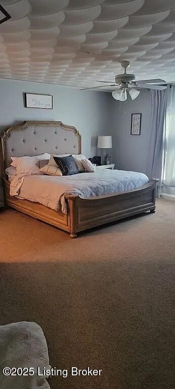 carpeted bedroom with a ceiling fan