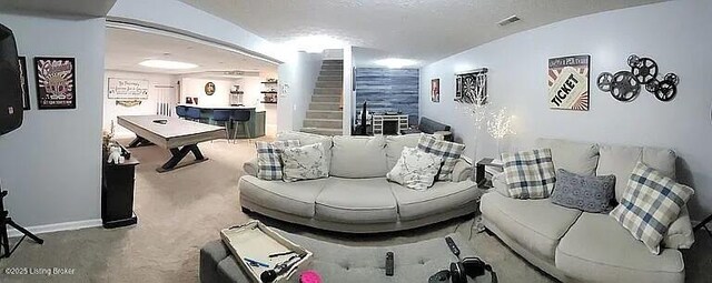 living area featuring stairway, carpet flooring, visible vents, and baseboards