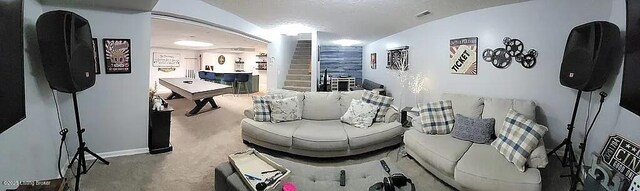 carpeted living room featuring arched walkways and visible vents