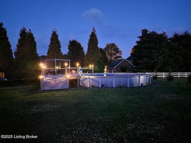 exterior space with fence and a lawn