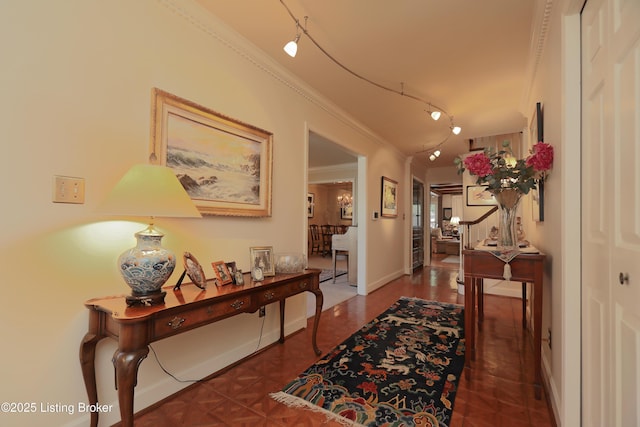 corridor with baseboards and ornamental molding