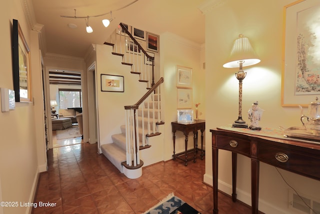 stairway with crown molding and baseboards