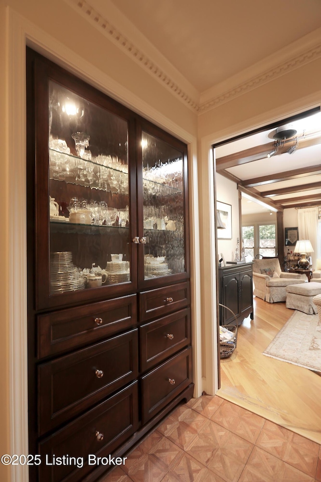 interior details with crown molding and parquet floors