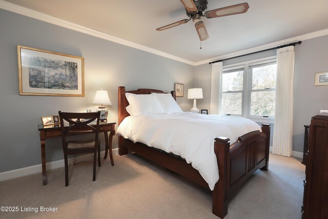 carpeted bedroom featuring ceiling fan, baseboards, and ornamental molding