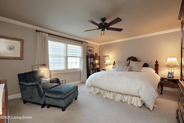 carpeted bedroom with ceiling fan, baseboards, and ornamental molding