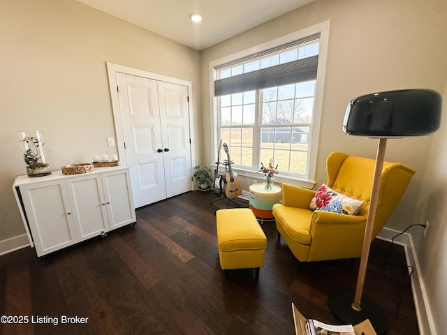 sitting room with dark wood-style flooring and baseboards