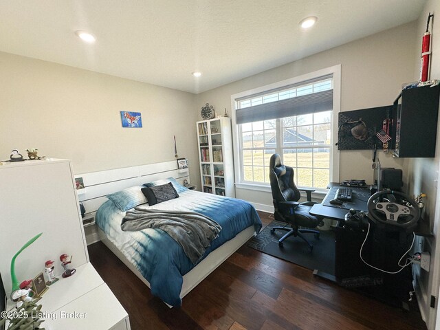 bedroom featuring baseboards, wood finished floors, and recessed lighting