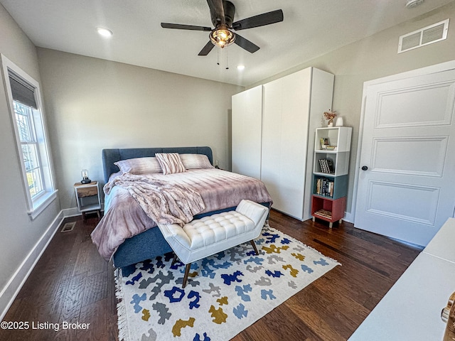 bedroom featuring dark wood-style flooring, recessed lighting, visible vents, and baseboards