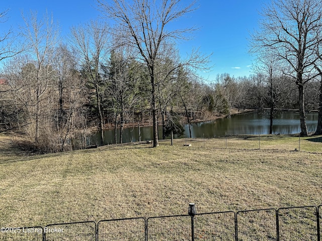 view of yard featuring a water view and fence