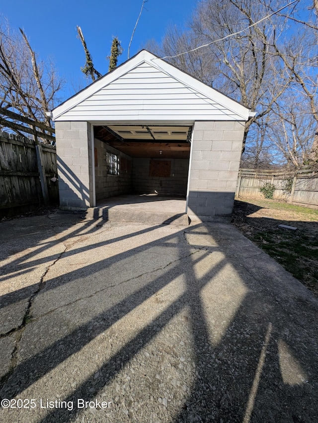 detached garage featuring fence