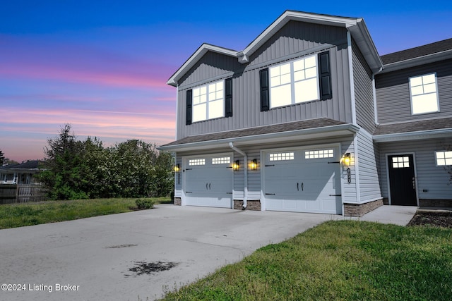 view of front of property with a garage, driveway, a shingled roof, and board and batten siding