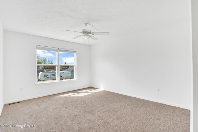 unfurnished room with a ceiling fan, baseboards, visible vents, and carpet flooring