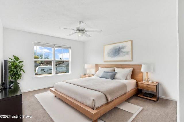 bedroom with ceiling fan, carpet flooring, and baseboards