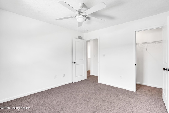 unfurnished bedroom featuring carpet, a closet, visible vents, and baseboards