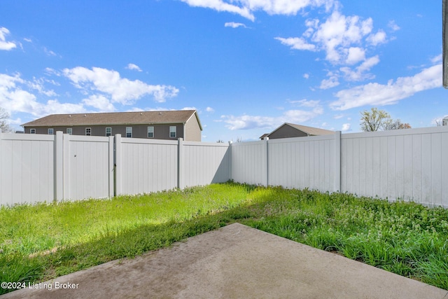 view of yard with a patio and a fenced backyard