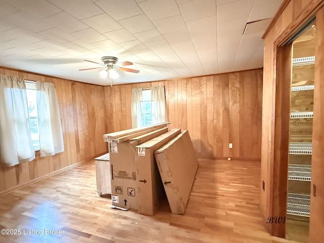 interior space featuring baseboards and wood finished floors