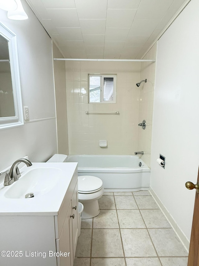 bathroom with toilet, vanity,  shower combination, tile patterned flooring, and baseboards