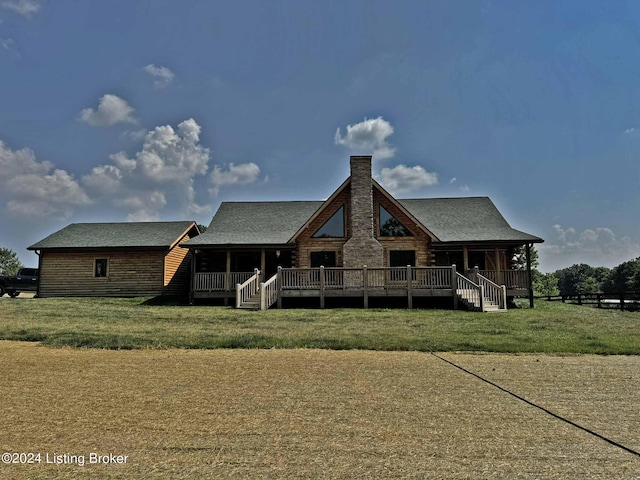 back of property featuring a yard and a chimney