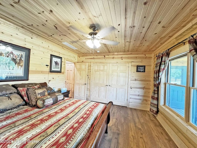 bedroom featuring wooden ceiling, wood finished floors, and wood walls