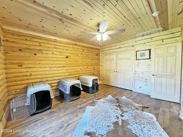 bedroom featuring wood ceiling, log walls, ceiling fan, and wood finished floors