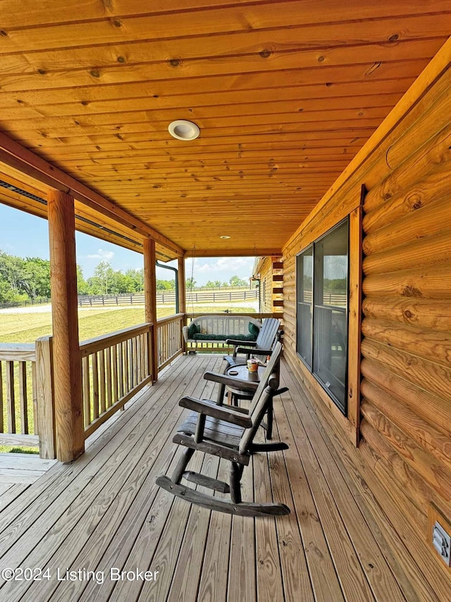 deck featuring covered porch and fence