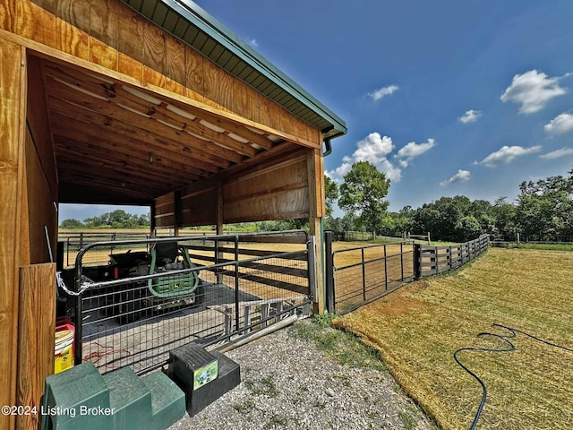 view of horse barn featuring a rural view