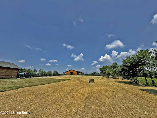 view of yard with an outbuilding and a rural view