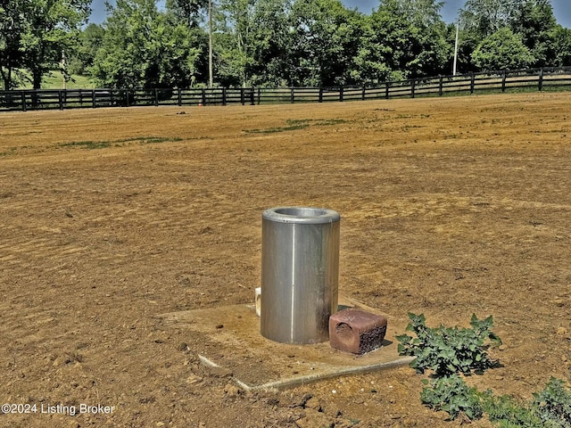 view of yard with a rural view and fence