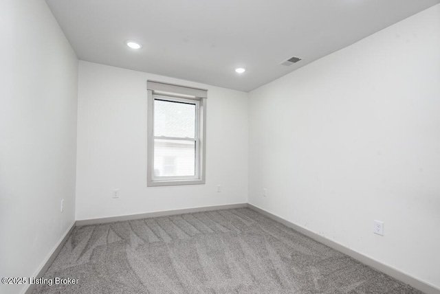 carpeted empty room featuring recessed lighting, visible vents, and baseboards