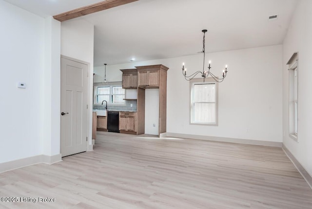 kitchen with a notable chandelier, light wood-style flooring, a sink, black dishwasher, and baseboards