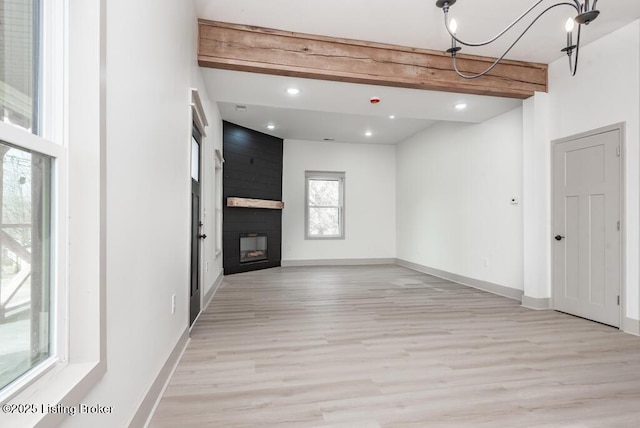 unfurnished living room with baseboards, beam ceiling, recessed lighting, a fireplace, and light wood-style floors