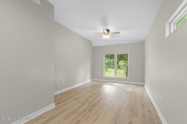 unfurnished room featuring a wealth of natural light, light wood finished floors, and baseboards