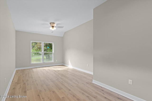 unfurnished room with ceiling fan, light wood-type flooring, and baseboards