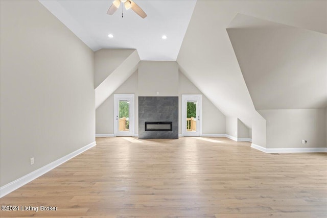 unfurnished living room with lofted ceiling, baseboards, ceiling fan, and light wood finished floors