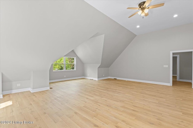 additional living space featuring baseboards, a ceiling fan, lofted ceiling, light wood-type flooring, and recessed lighting