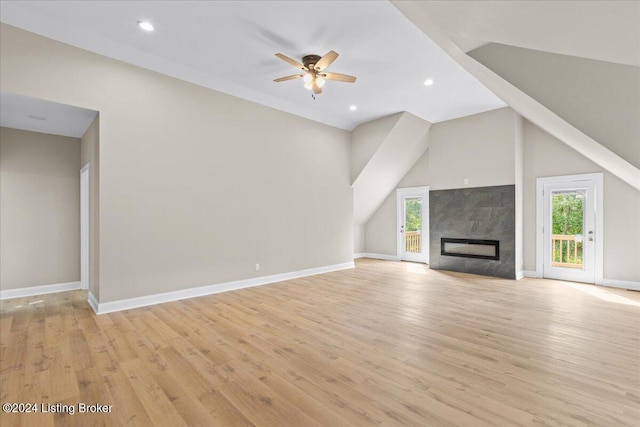 unfurnished living room featuring baseboards, ceiling fan, light wood-style floors, a fireplace, and recessed lighting