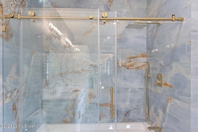 bathroom with a marble finish shower