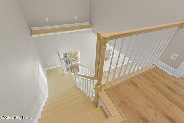 stairs with baseboards and wood finished floors