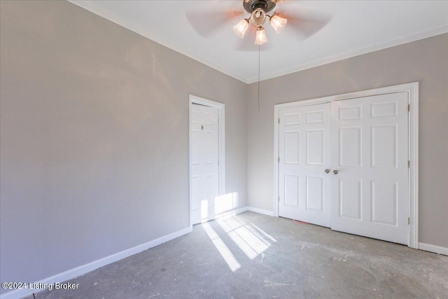 unfurnished bedroom featuring concrete floors, baseboards, and a closet