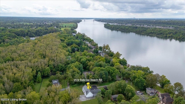 drone / aerial view featuring a water view and a wooded view