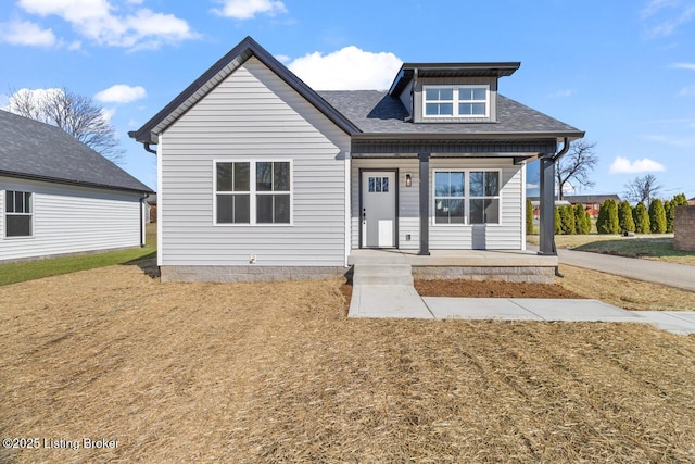 bungalow-style home with a shingled roof and a porch