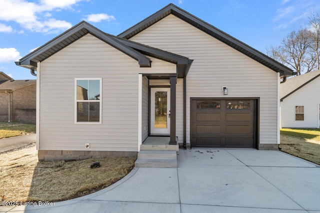 view of front of home featuring concrete driveway and an attached garage