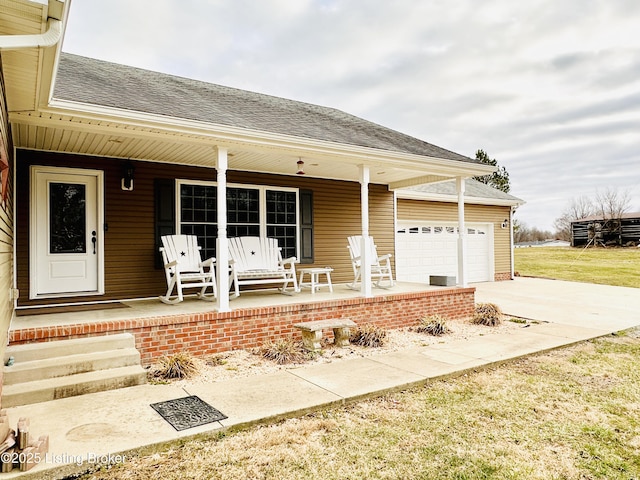 view of front of property featuring covered porch, an attached garage, concrete driveway, and roof with shingles