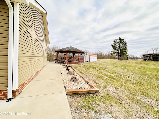 view of yard with a gazebo, a storage unit, and an outdoor structure