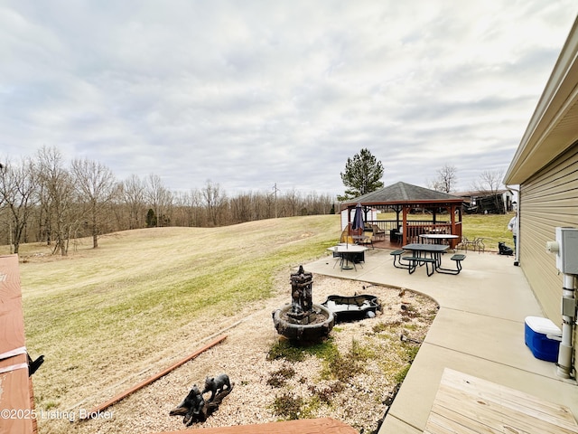 view of yard featuring a gazebo, a patio area, and an outdoor fire pit