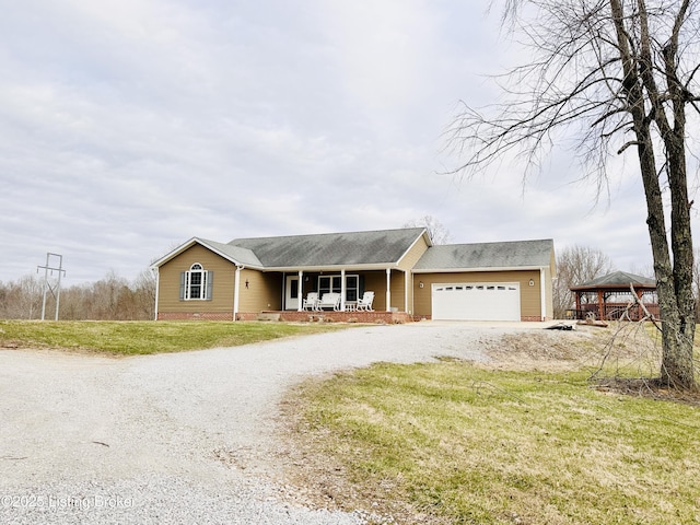 view of front of home with driveway, a porch, a gazebo, a front lawn, and a garage