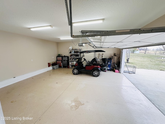 garage with a garage door opener and baseboards