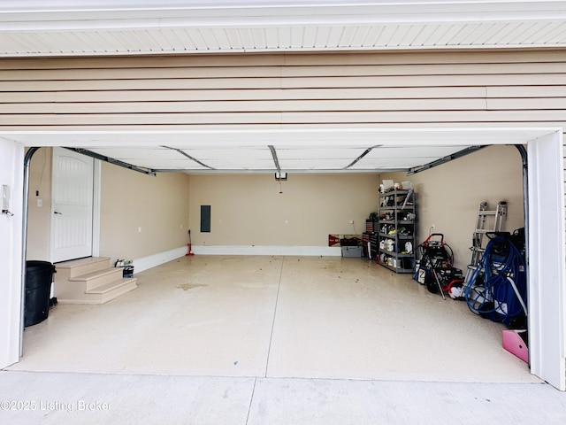 garage with electric panel and baseboards