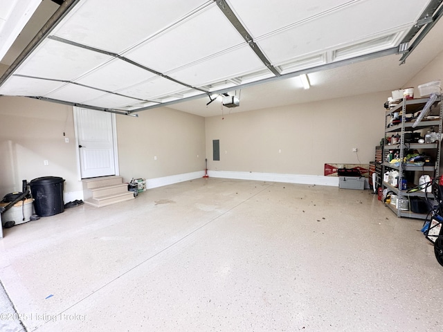 garage with electric panel, baseboards, and a garage door opener