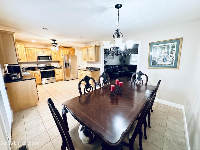 dining space featuring light tile patterned floors, baseboards, recessed lighting, and ceiling fan with notable chandelier